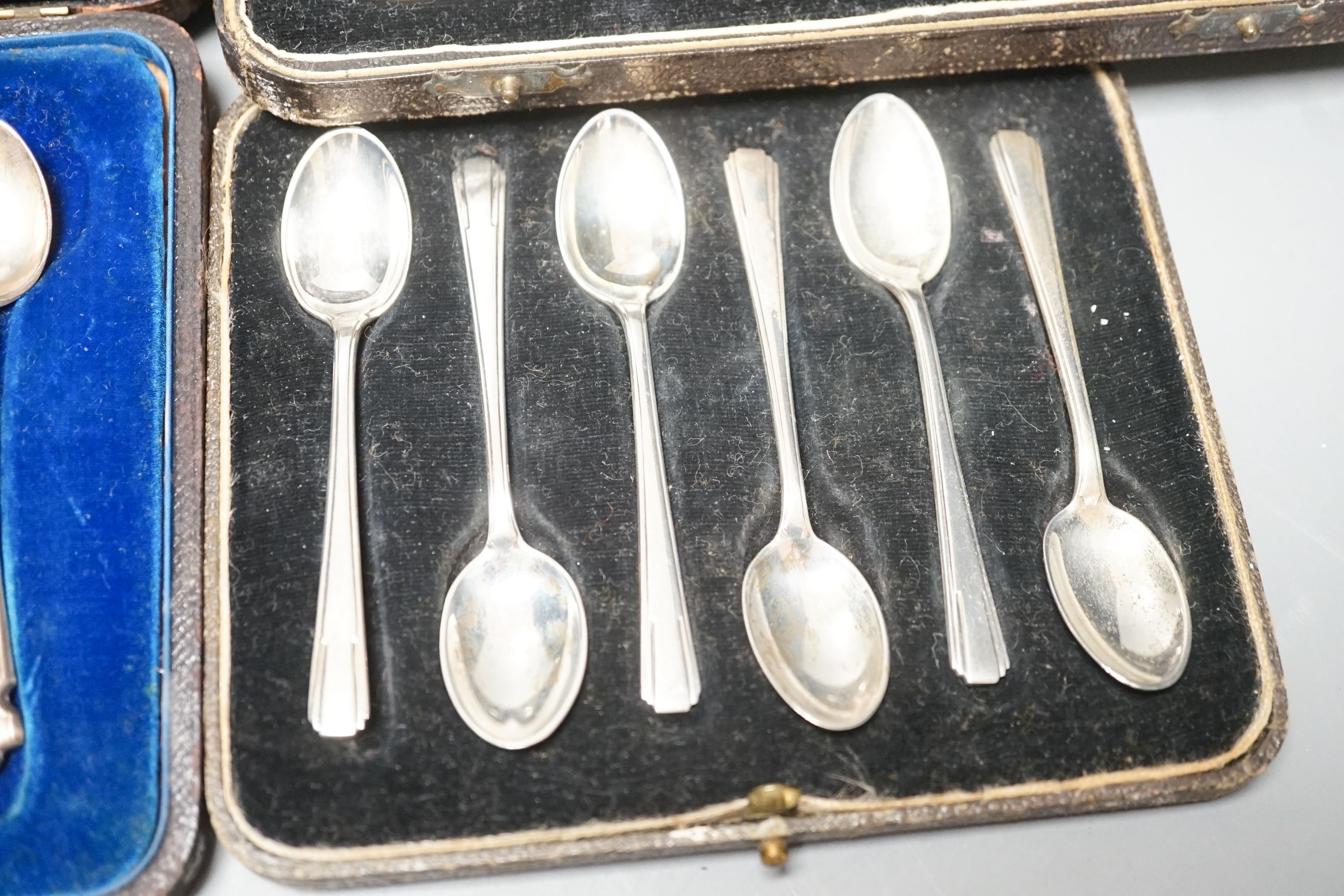 Four cased sets of cutlery including silver teaspoons and pair of silver preserve spoons and a silver cigarette case.